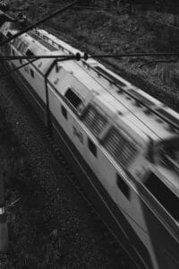 A black and white photo of a train passing by