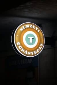 a neon sign hanging from the side of a building