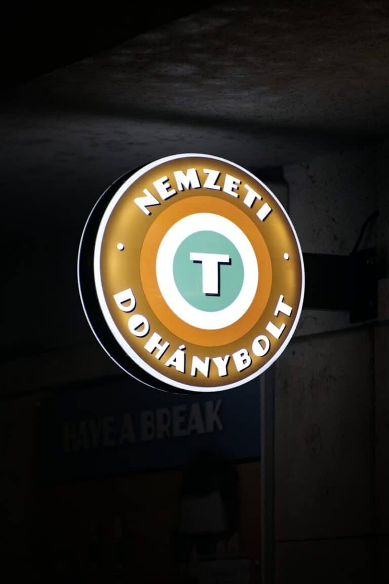 a neon sign hanging from the side of a building