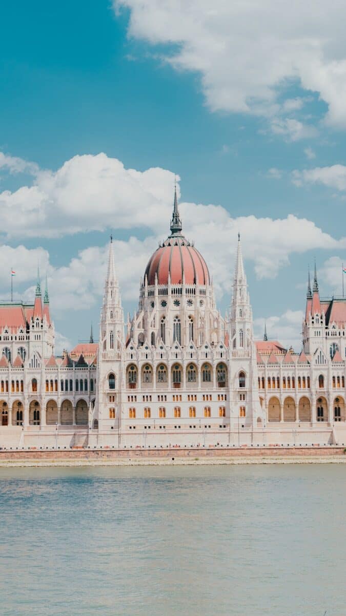 a large building with a domed roof with Hungarian Parliament Building in the background
