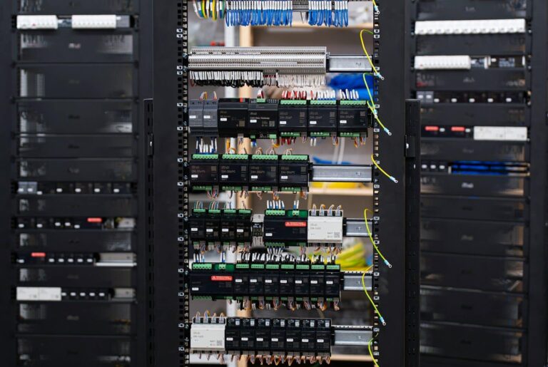 Open electrical control panel with wires and circuit breakers.